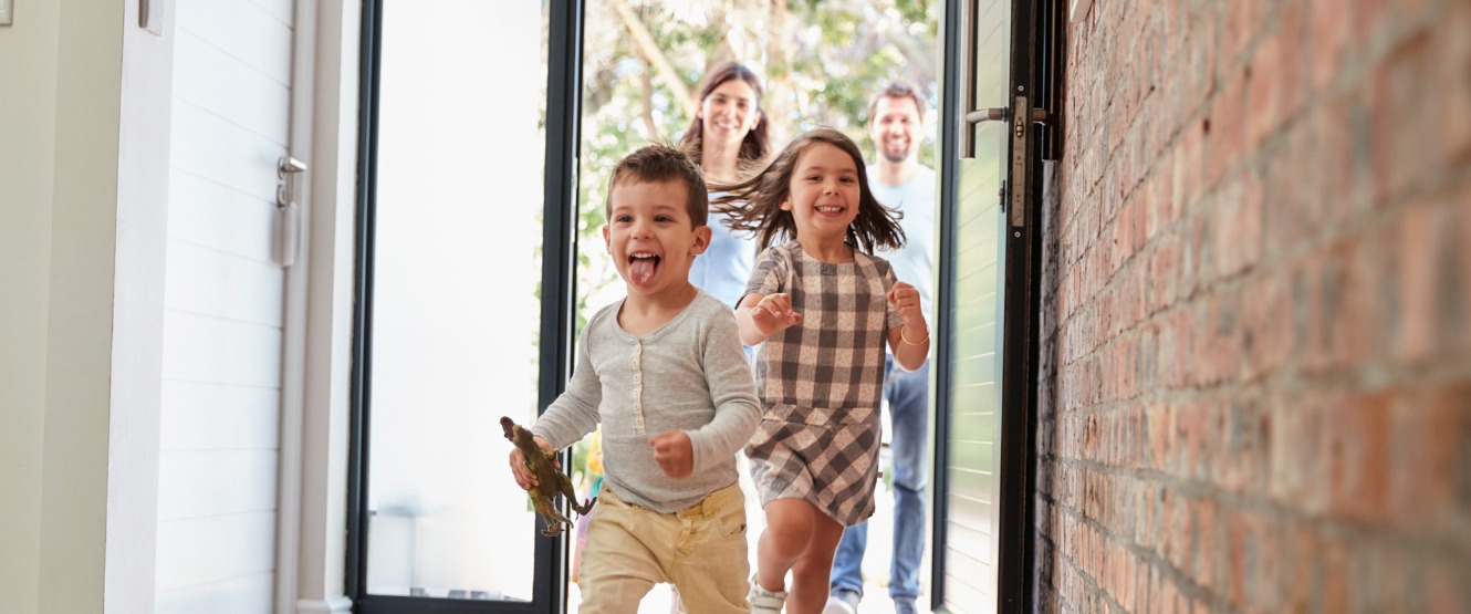 excited children arriving home with parents